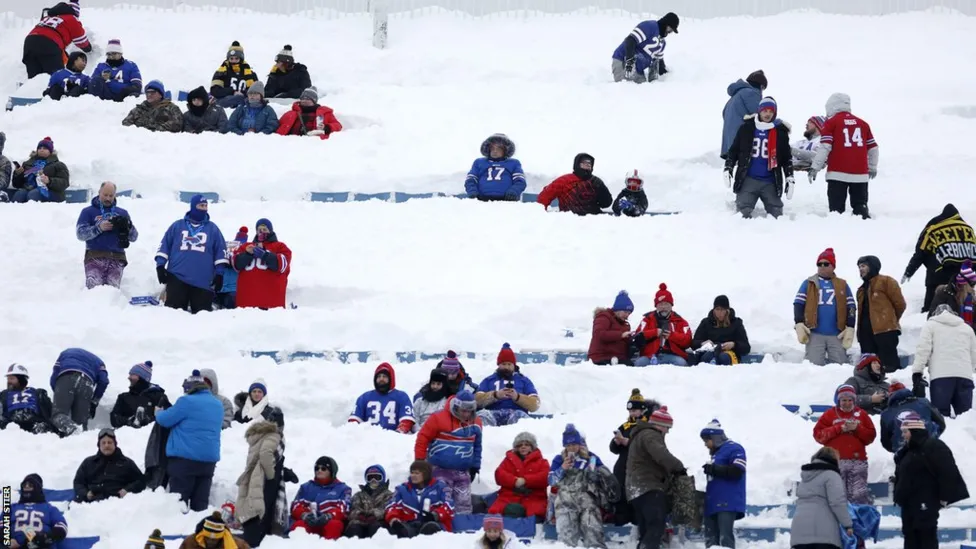 Fans at the Bills game had to clear the snow to get to their seats